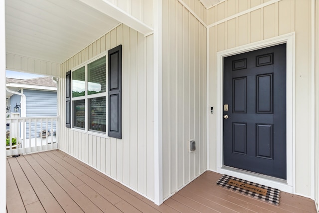 view of exterior entry featuring covered porch