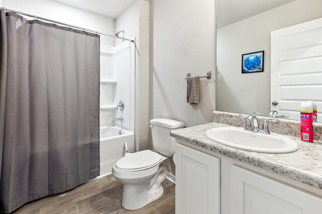 full bathroom with shower / bathtub combination with curtain, wood-type flooring, toilet, and vanity