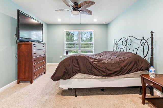 carpeted bedroom with ceiling fan