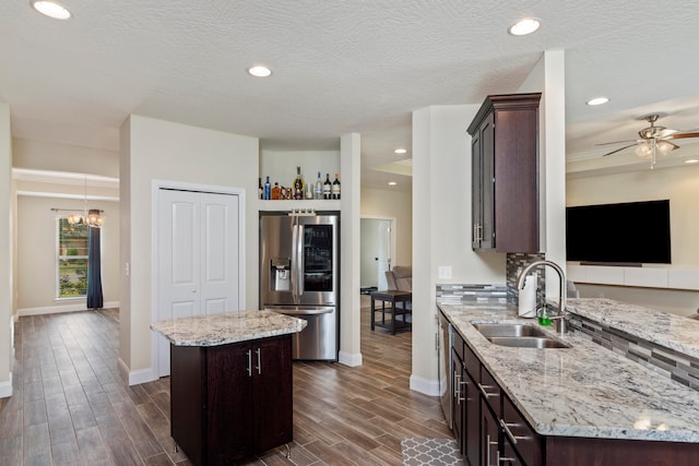 kitchen with stainless steel fridge, sink, dark hardwood / wood-style flooring, and a kitchen island