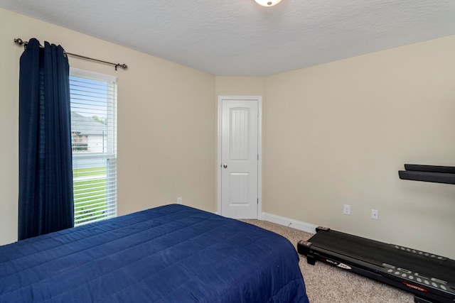 carpeted bedroom featuring a textured ceiling