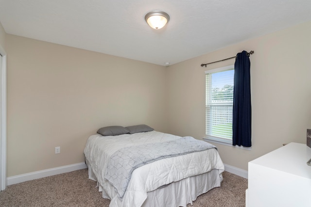 bedroom with light colored carpet