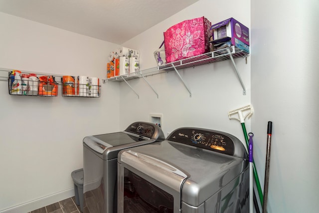 clothes washing area featuring hardwood / wood-style flooring and washing machine and clothes dryer