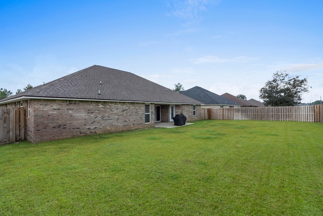 back of house featuring a yard and a patio area