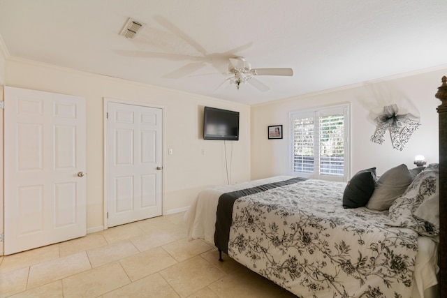 tiled bedroom with ceiling fan and ornamental molding