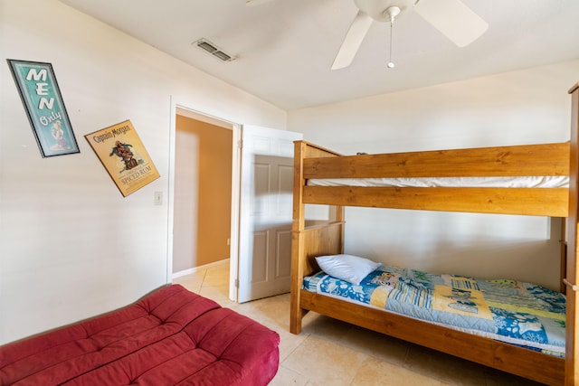 bedroom with ceiling fan and light tile patterned flooring