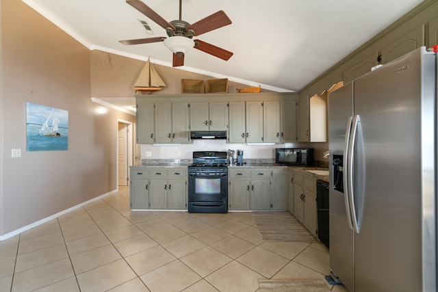 kitchen featuring crown molding, light tile patterned flooring, black appliances, and vaulted ceiling