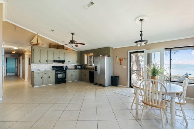 kitchen with light tile patterned flooring, a water view, black appliances, ceiling fan with notable chandelier, and ornamental molding