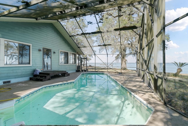 view of swimming pool featuring a lanai, a patio area, and a water view