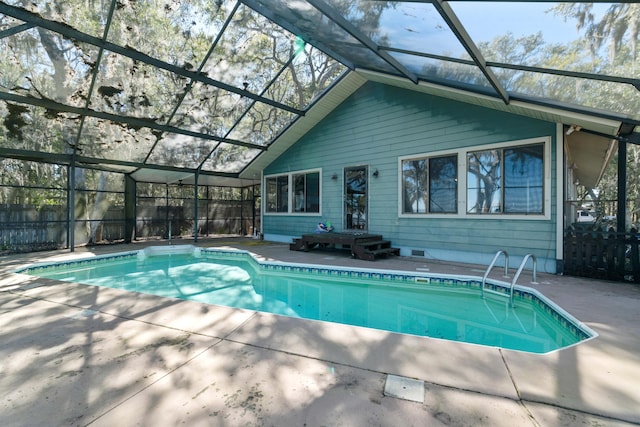 view of swimming pool with a patio and a lanai