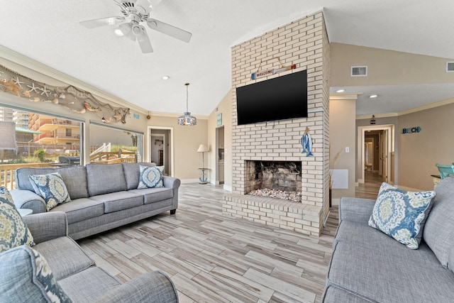 living room with ornamental molding, ceiling fan, a fireplace, and brick wall