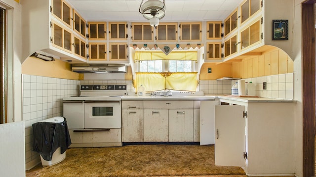 kitchen featuring white cabinets, white range with electric stovetop, wall chimney range hood, and tasteful backsplash