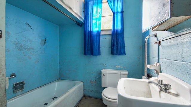 bathroom featuring sink, toilet, and a bathtub