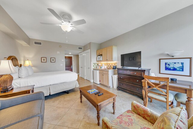 bedroom with a closet, ceiling fan, and light tile floors