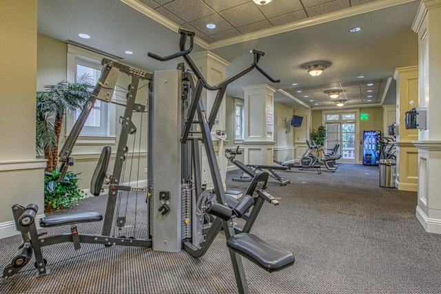 gym with ornamental molding and carpet flooring