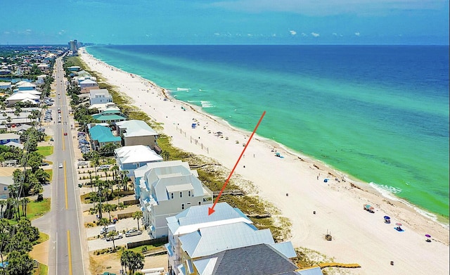 bird's eye view featuring a water view and a beach view