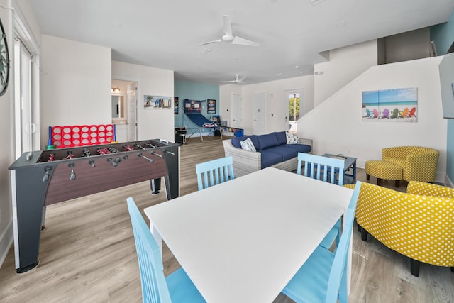 recreation room featuring light hardwood / wood-style floors and ceiling fan