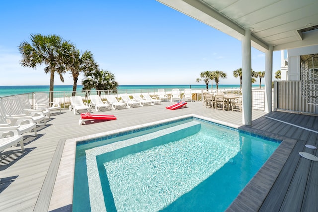 view of swimming pool featuring a deck with water view