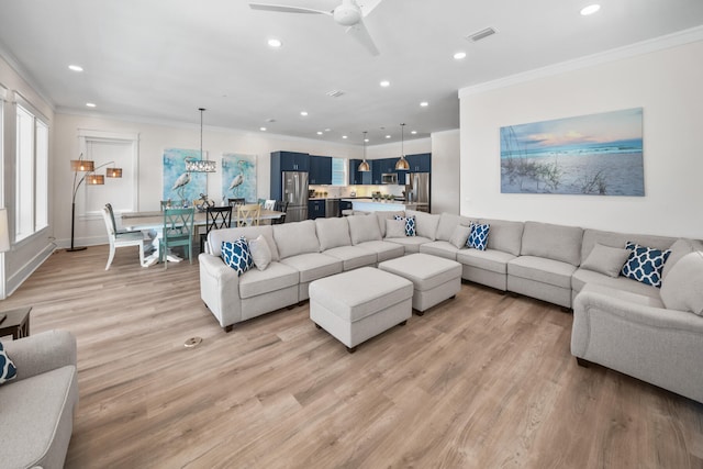 living room with ceiling fan, crown molding, and light wood-type flooring