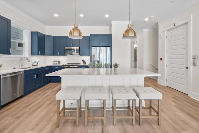 kitchen featuring backsplash, appliances with stainless steel finishes, and decorative light fixtures