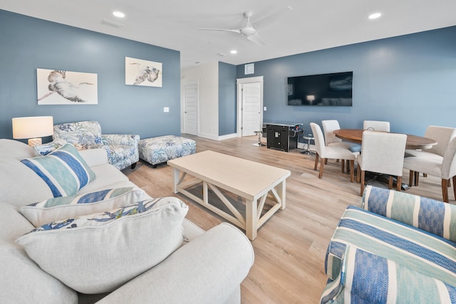 living room with ceiling fan and light wood-type flooring