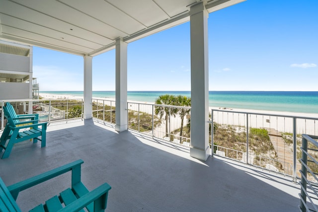 balcony featuring a water view and a beach view