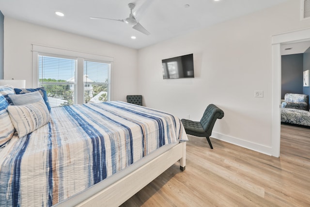 bedroom with light hardwood / wood-style flooring and ceiling fan