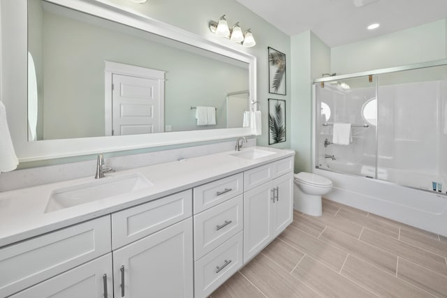 full bathroom featuring double sink vanity, toilet, shower / bath combination with glass door, and tile floors