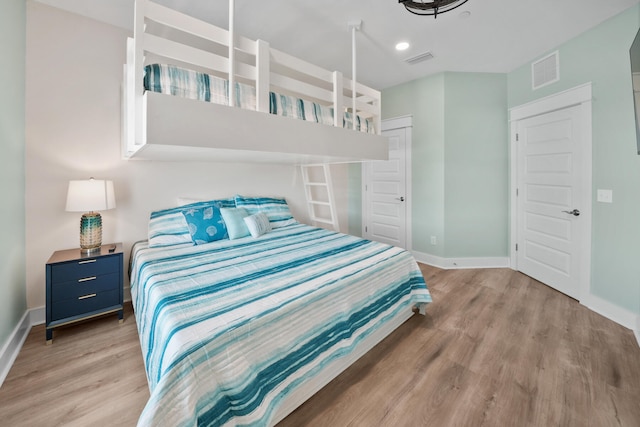 bedroom featuring hardwood / wood-style floors and a closet