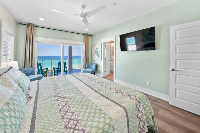 bedroom with multiple windows, ceiling fan, and hardwood / wood-style flooring