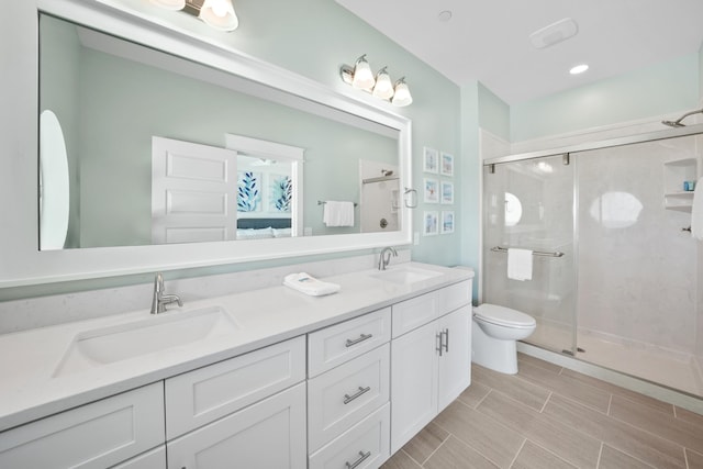 bathroom with an enclosed shower, double vanity, tile flooring, and toilet