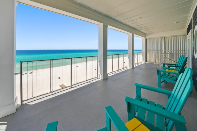 balcony with a beach view and a water view