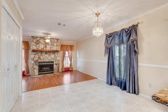 unfurnished living room with crown molding, hardwood / wood-style flooring, and a stone fireplace