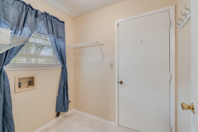 washroom featuring tile flooring and hookup for a washing machine