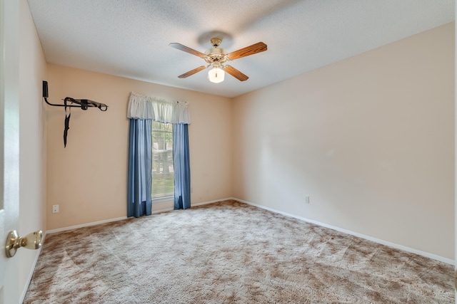 unfurnished room with ceiling fan, carpet, and a textured ceiling