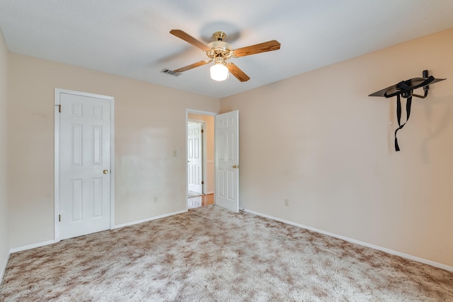 unfurnished bedroom with ceiling fan and carpet