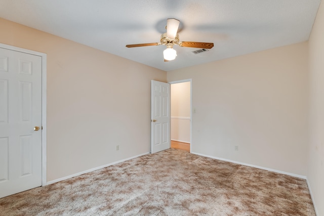 carpeted empty room with ceiling fan