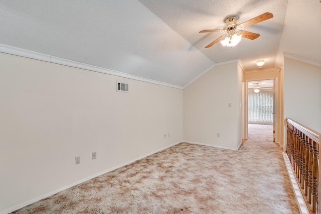 additional living space with light carpet, ceiling fan, a textured ceiling, and lofted ceiling