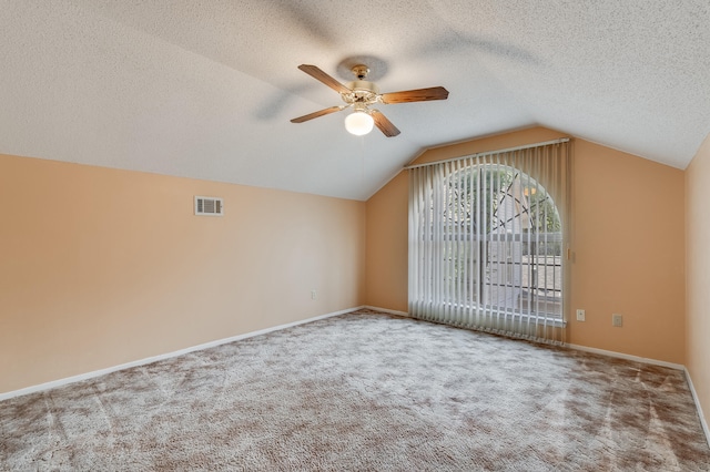 bonus room featuring lofted ceiling, ceiling fan, carpet floors, and a textured ceiling