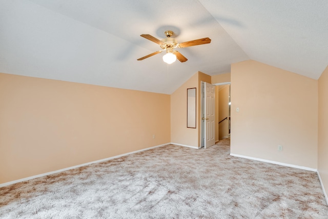 additional living space with light carpet, ceiling fan, and lofted ceiling