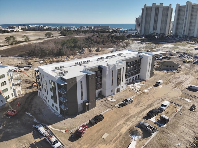 drone / aerial view featuring a view of city and a water view