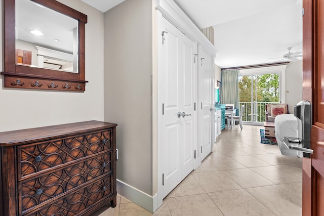 hall featuring light tile floors