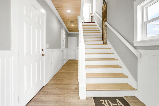 stairs with hardwood / wood-style flooring and wooden ceiling