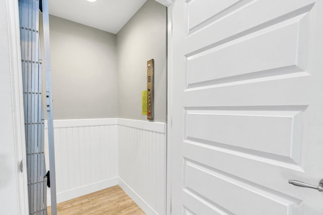 room details with hardwood / wood-style flooring and elevator