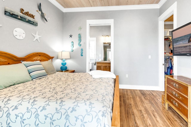 bedroom featuring wooden ceiling, wood-type flooring, ornamental molding, and ensuite bath