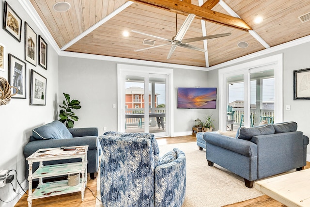 living room featuring lofted ceiling, a healthy amount of sunlight, and wooden ceiling