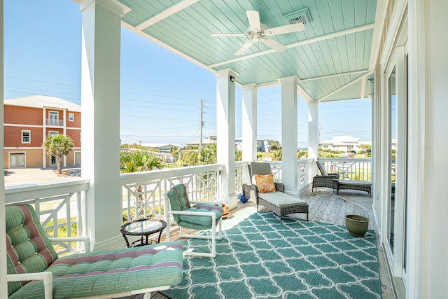 sunroom / solarium with wooden ceiling, ceiling fan, and a healthy amount of sunlight