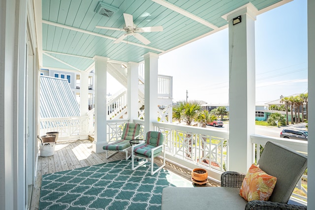 sunroom / solarium featuring ceiling fan and wood ceiling