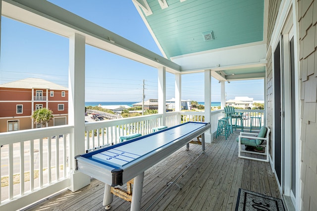 wooden terrace with a water view