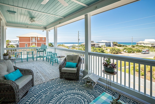 deck featuring a water view and covered porch